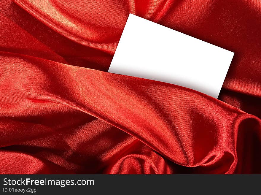 Blank White Card On Red Colored Satin Cloth