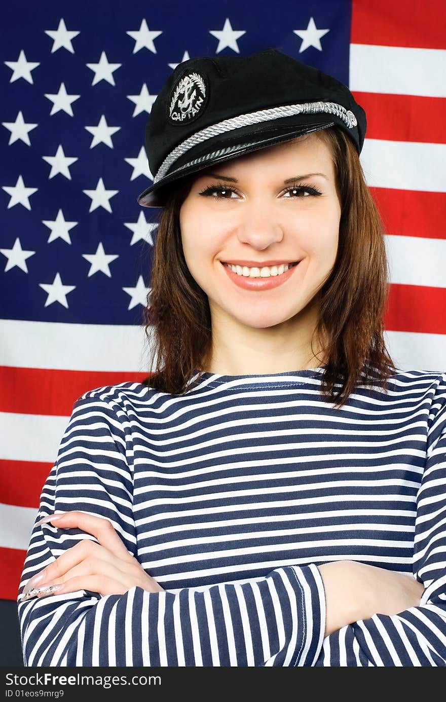 Beautiful young confident sailor near the American flag. Beautiful young confident sailor near the American flag