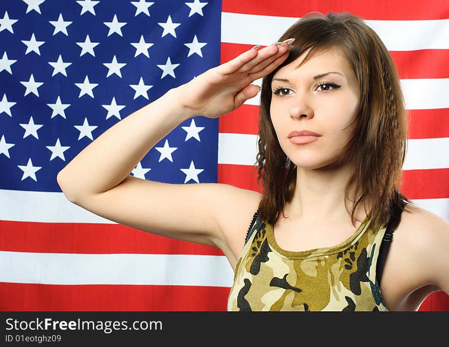 Young Woman Wearing Camouflage Salutes