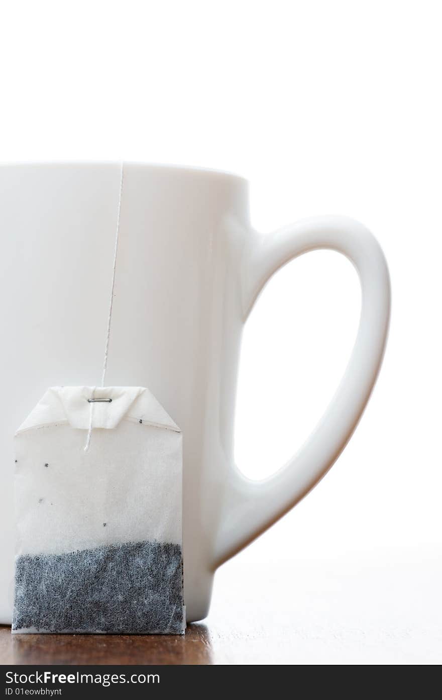 Teabag and teacup isolated on white background