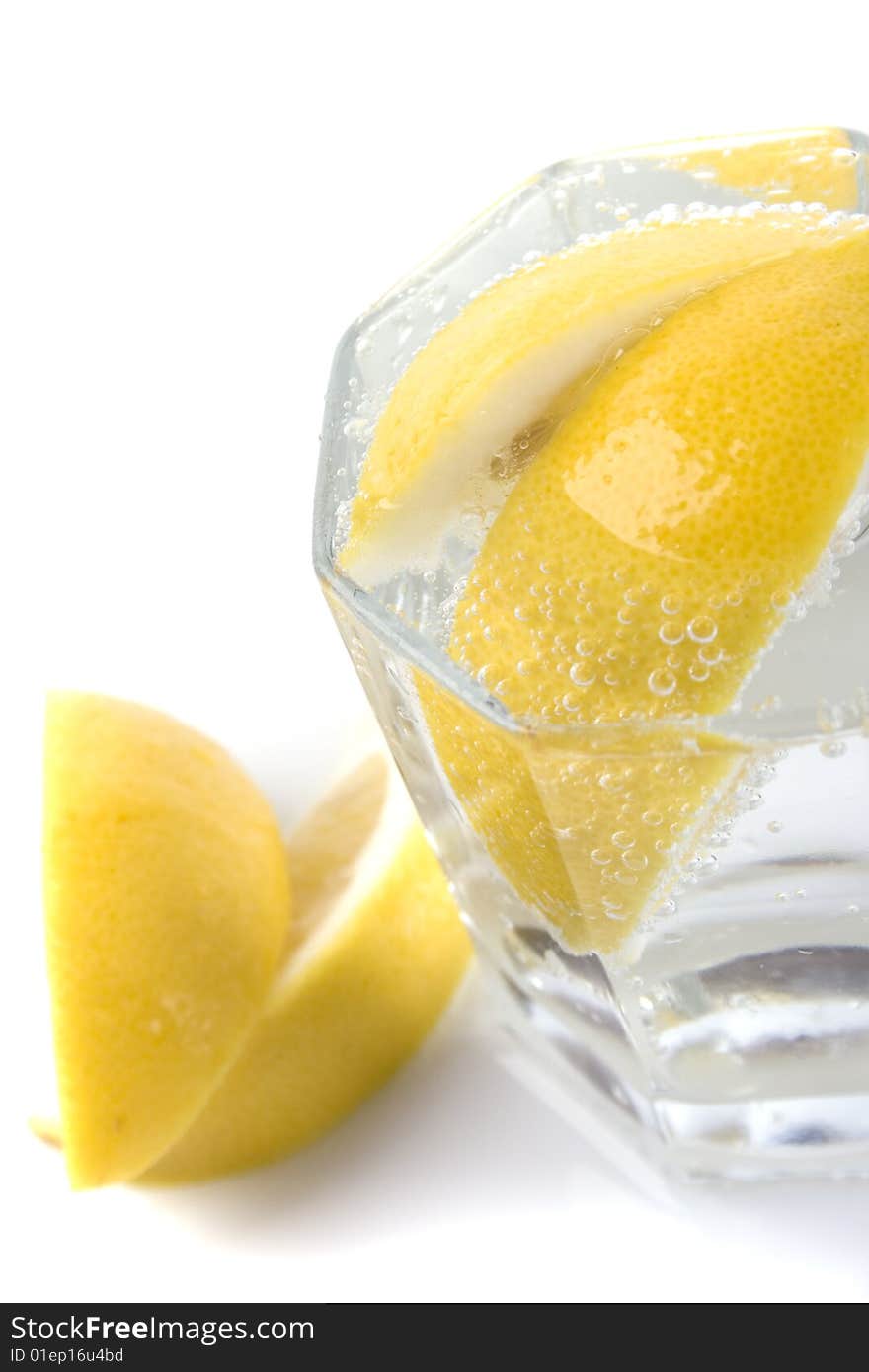 Glass with soda water and lemon slices