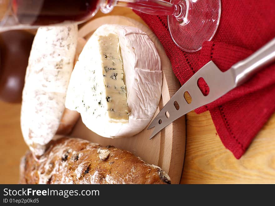 French cheese,salami,loaf of bread and red wine. French cheese,salami,loaf of bread and red wine