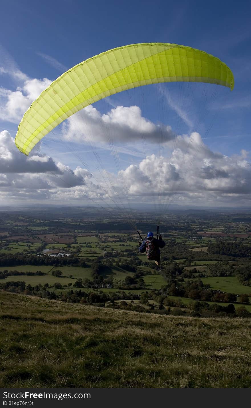 A paraglider with a lofty view of English countryside