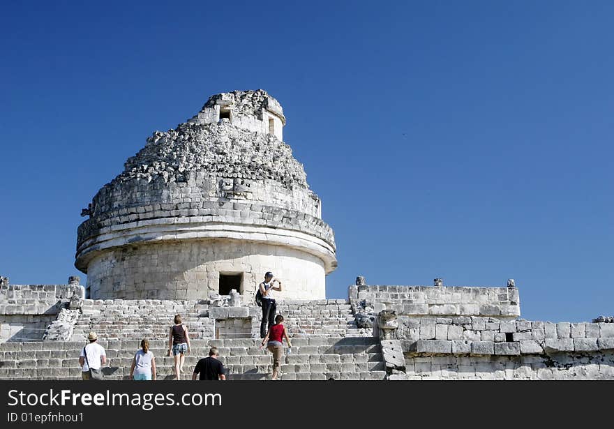 Tourists walking up stone steps of this mayan temple ruin. Tourists walking up stone steps of this mayan temple ruin