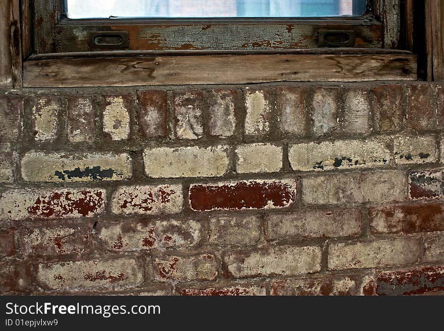 Old painted brick under rotting windowsill. Old painted brick under rotting windowsill