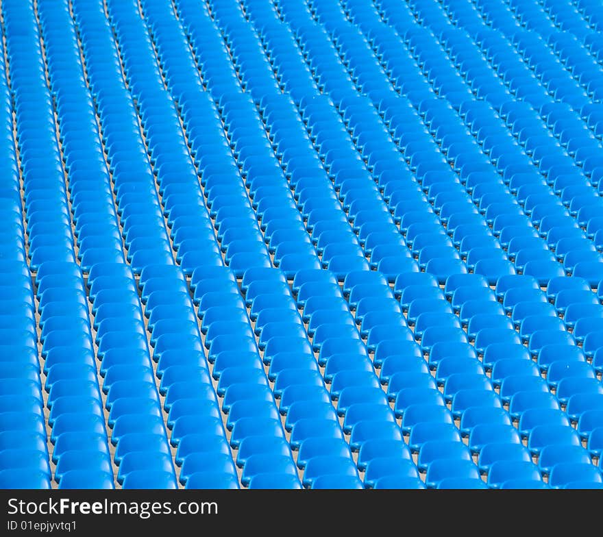 Abstract created by the repeating patterns of stadium seats. Abstract created by the repeating patterns of stadium seats