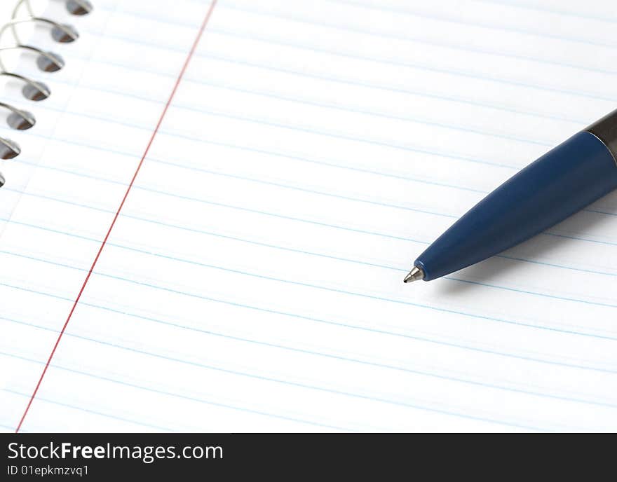 A macro picture of a pen and notebook