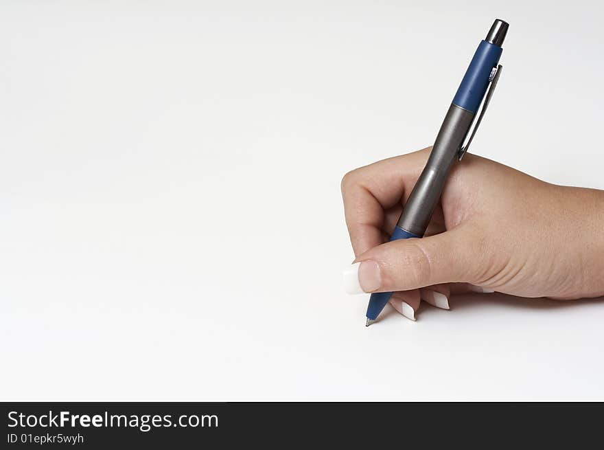 A macro picture of a female hand holding a pen. A macro picture of a female hand holding a pen