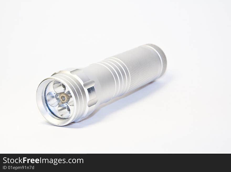 Aluminium led flashlight turned off isolated on white background. Aluminium led flashlight turned off isolated on white background