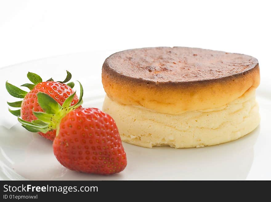 Cheesecake with fresh strawberries and blackberry jam isolated over white