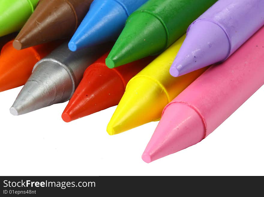 A set of colourful crayons on a white background, pink, red, blue, green, purple, silver