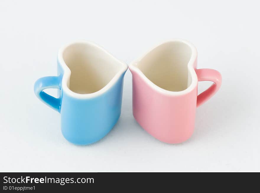 Two heart-shape cups on white background