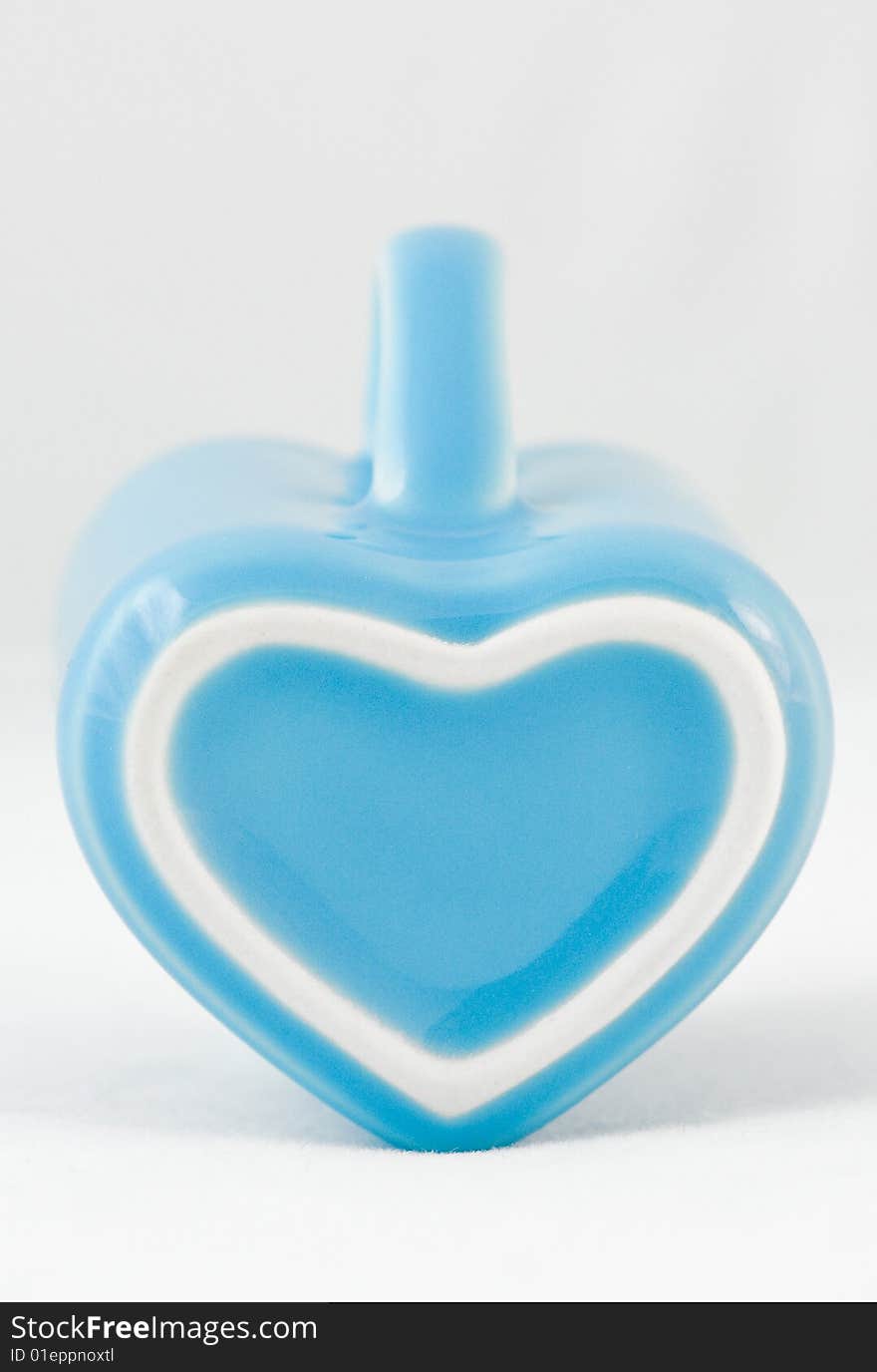 Heart-shape cup on white background