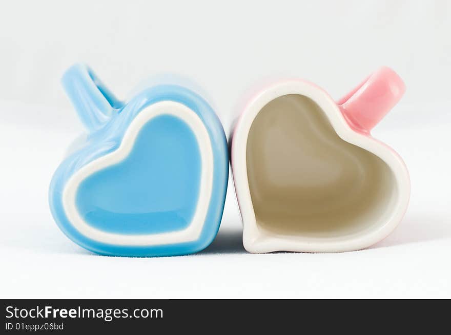 Two heart-shape cups on white background