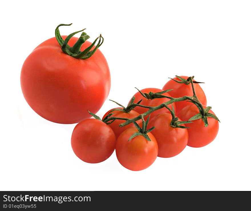 Large tomato and branch of cherry tomatoes