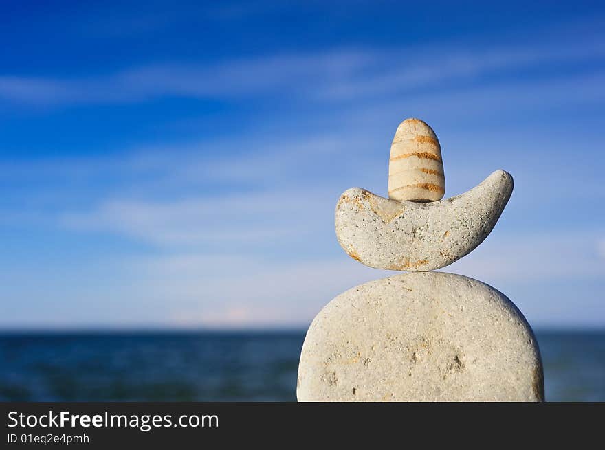 Sea pebble against the dark blue sky in the summer on a beach. Sea pebble against the dark blue sky in the summer on a beach