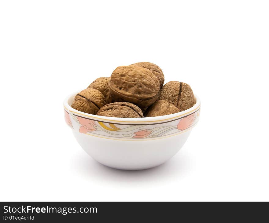 Walnuts in saucer isolated on white background with  path