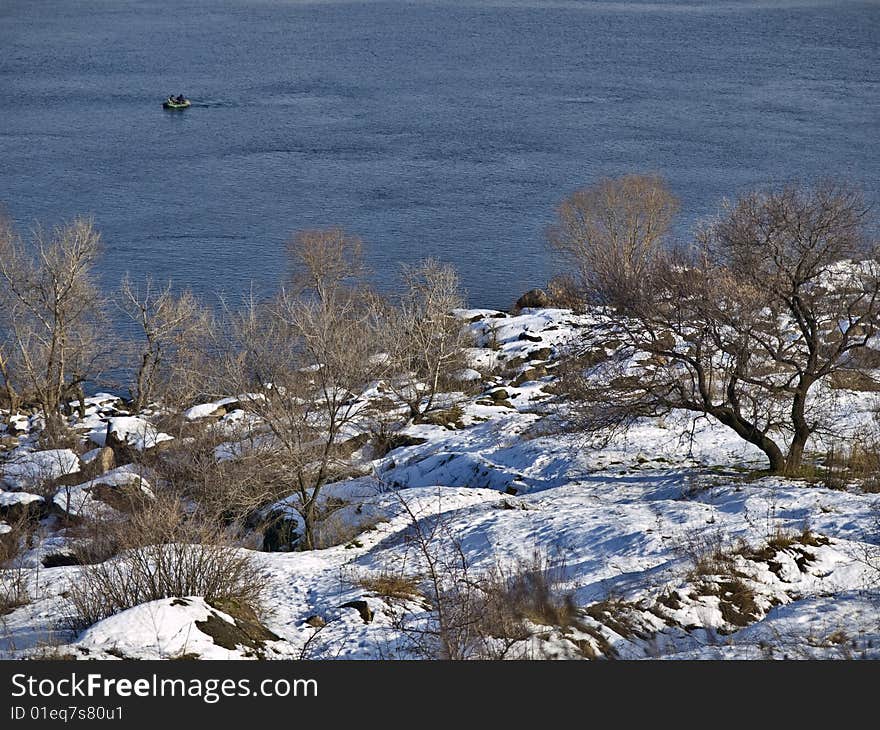 Winter landscape with fishermen and rocky bank. Winter landscape with fishermen and rocky bank