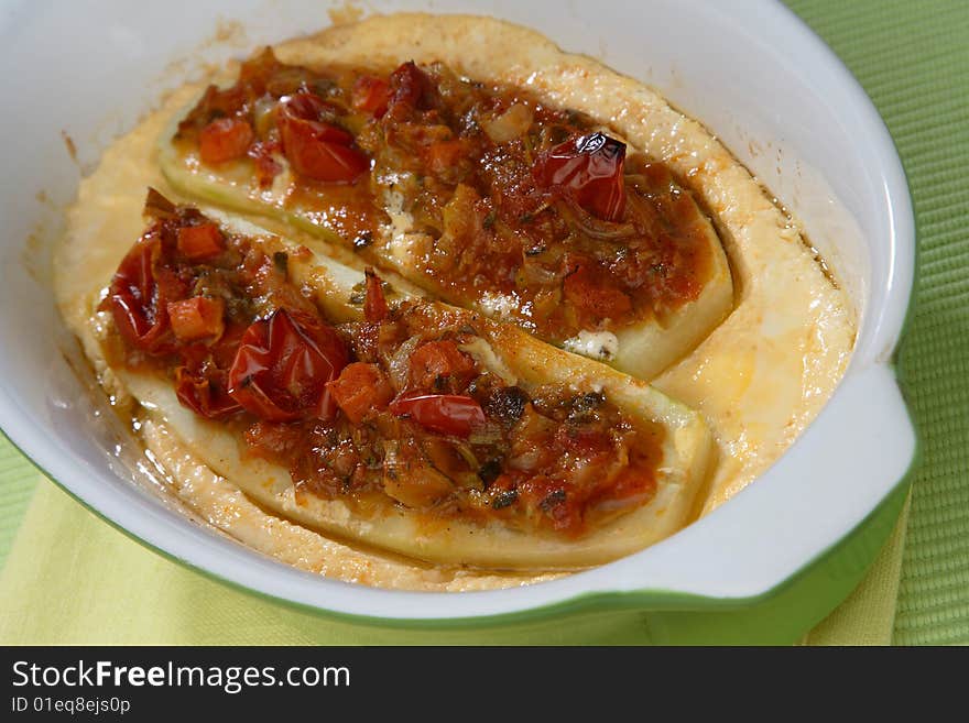 Cucumbers cut in half with vegetable filling in pastry on plate