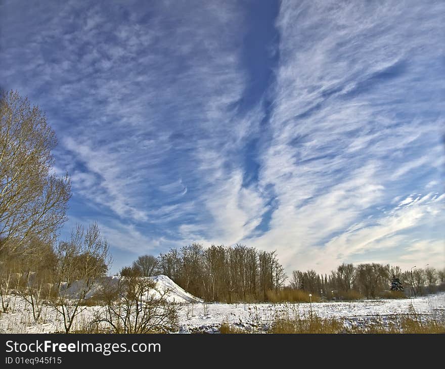 Winter landscape with the dark blue sky and plumose clouds. Winter landscape with the dark blue sky and plumose clouds