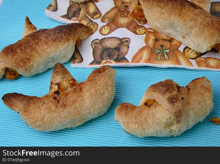 Baked puff pastry rolls filled with carrots on table