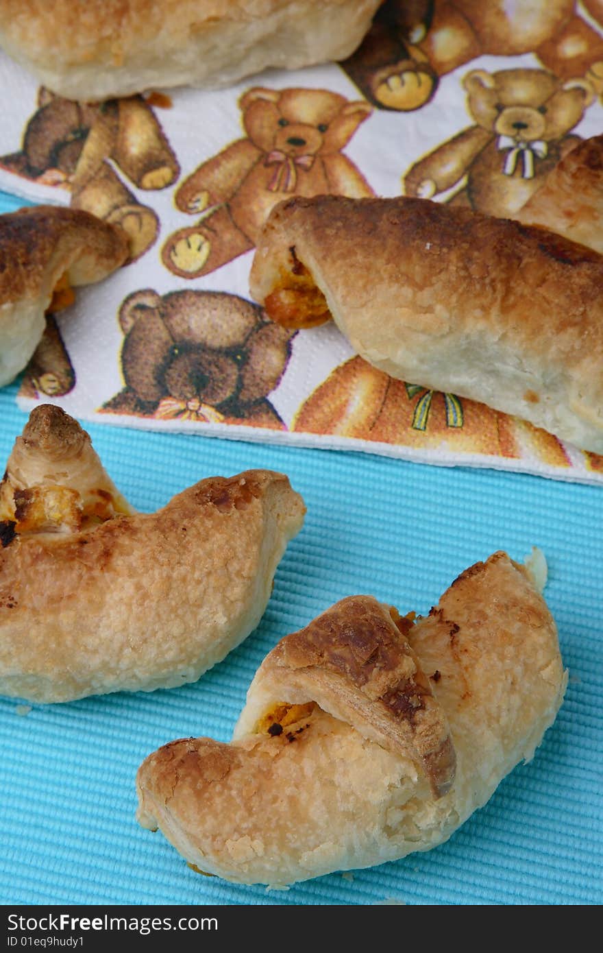 Baked puff pastry rolls filled with carrots on table