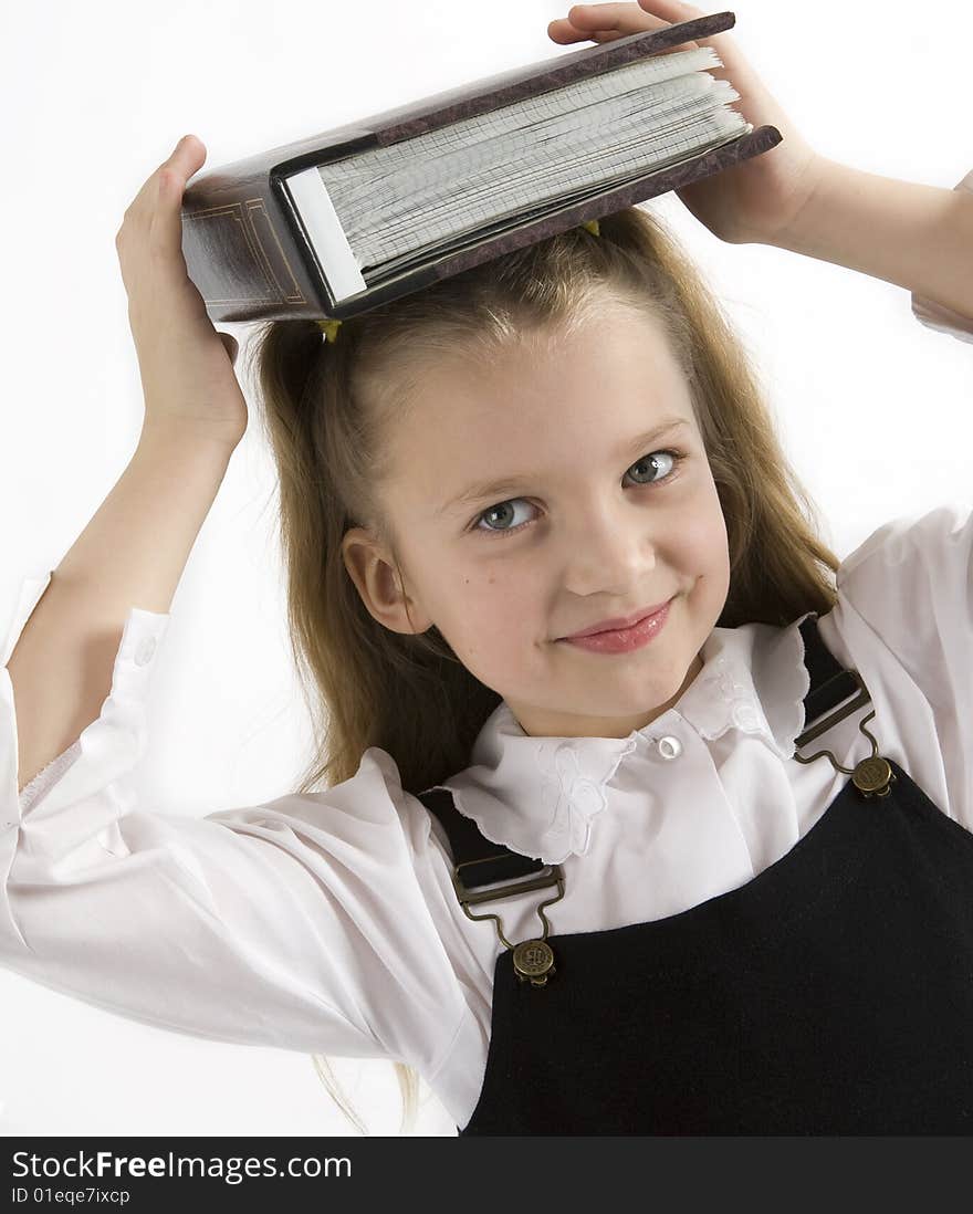 Young schoolgirl writing in a classroom