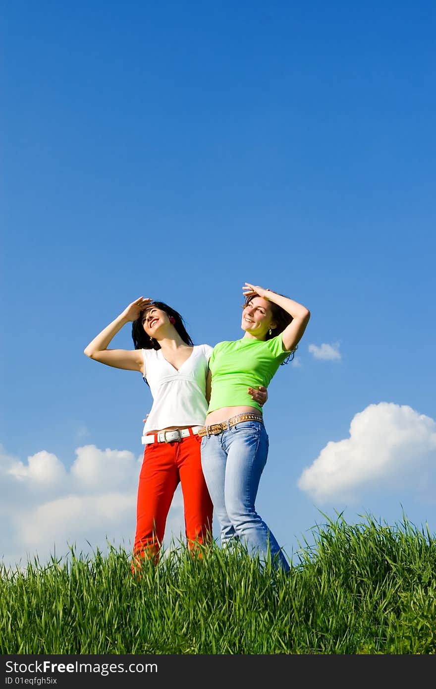 Two happy young women dreams to fly on winds