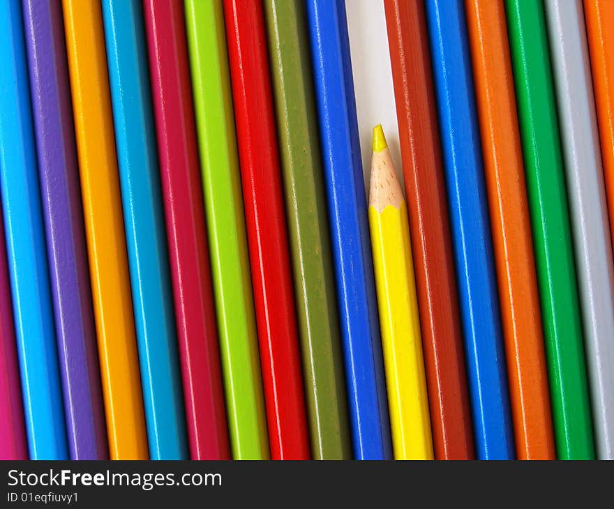 Yellow pencil among colorful ones set