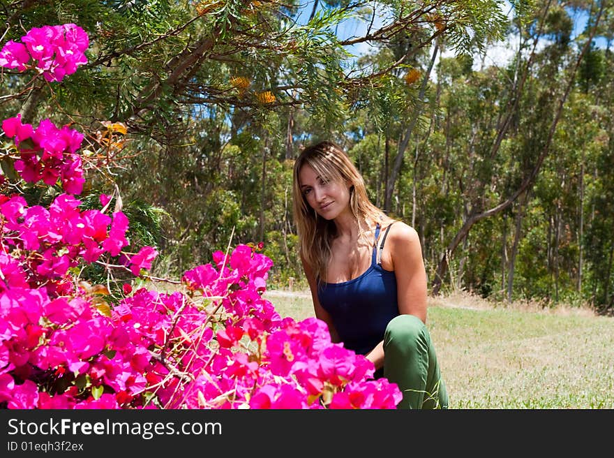 Woman front of bugonvia flowers. Woman front of bugonvia flowers