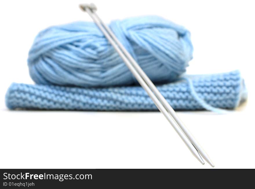 Two knitting needles, woollen yarn (worsted) clew and knitting cloth. Two knitting needles, woollen yarn (worsted) clew and knitting cloth.