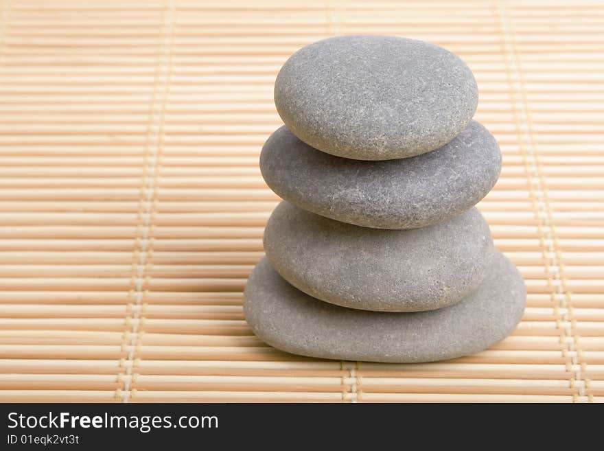 Balanced stones isolated in bamboo background