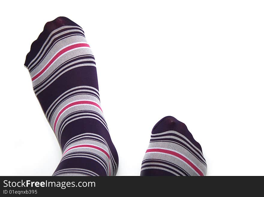 Beautiful legs in funny socks over white