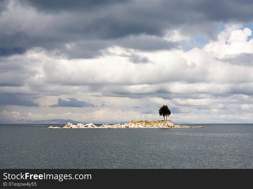 A single tree on and rocky island on Lake Titicaca. A single tree on and rocky island on Lake Titicaca.