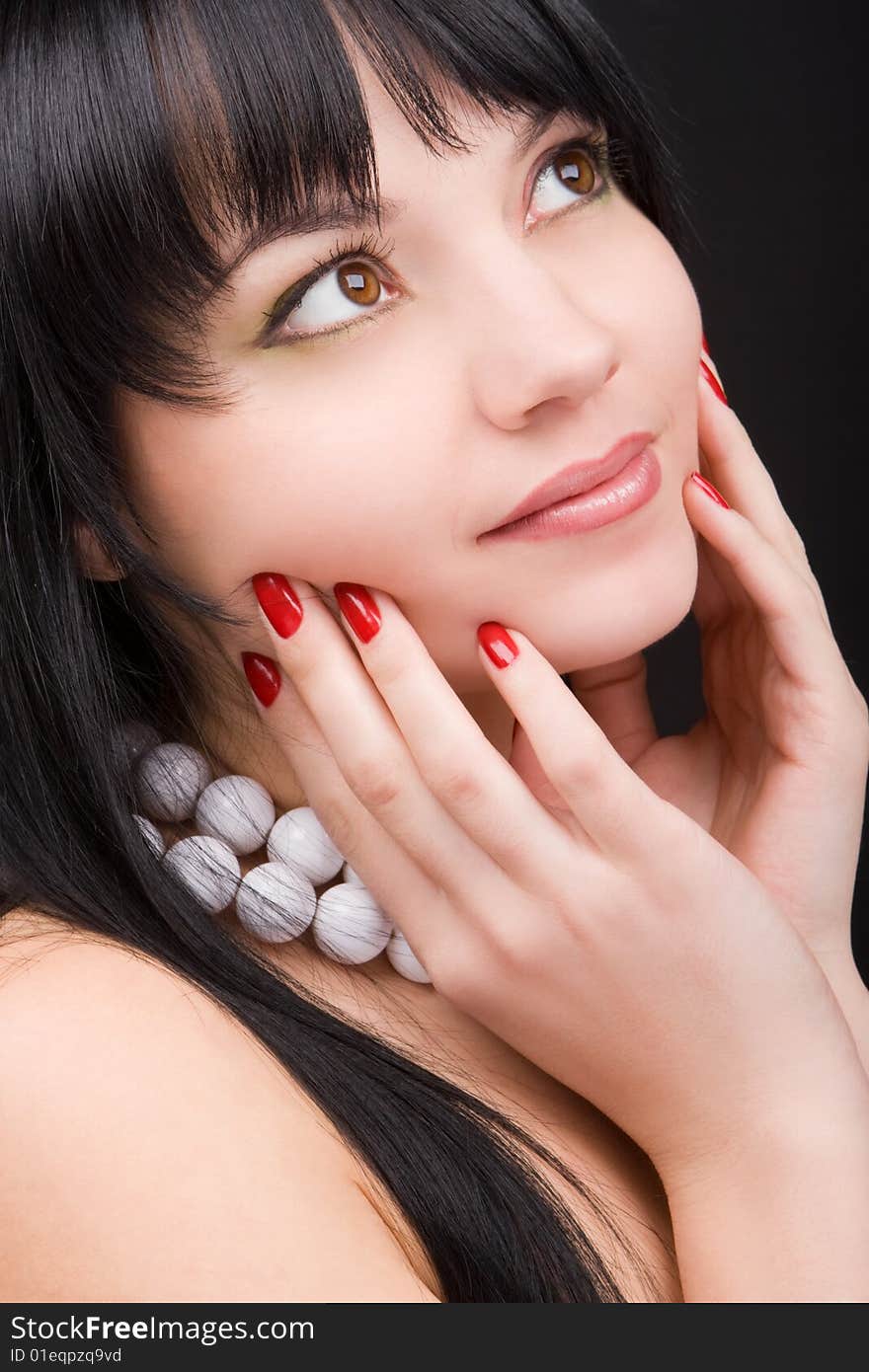 Portrait of the charming woman on black background