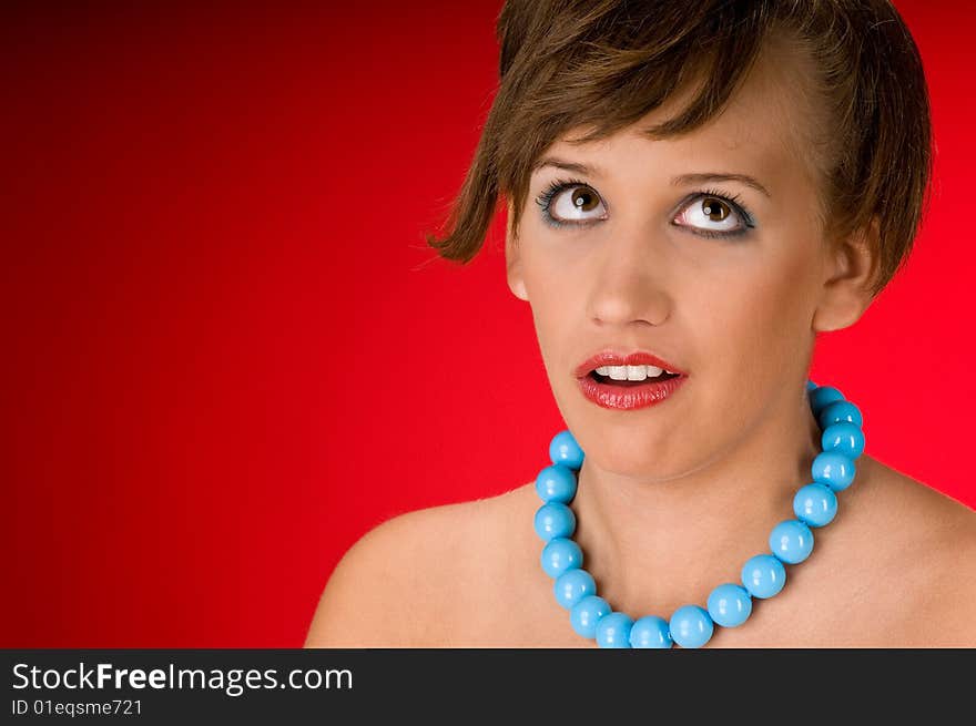 Portrait of young woman on red background