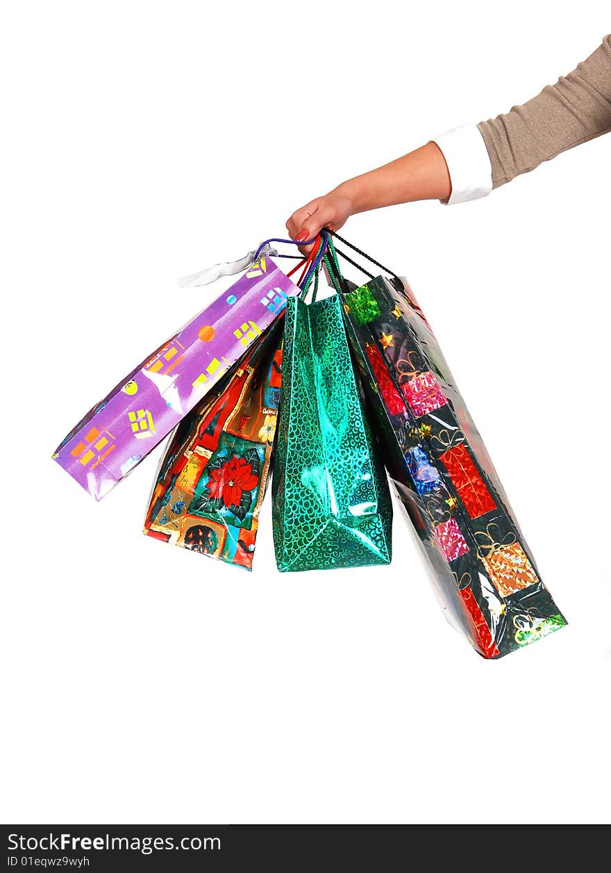 A woman's arm holding several colorful shopping bags in the picture with white background. A woman's arm holding several colorful shopping bags in the picture with white background.