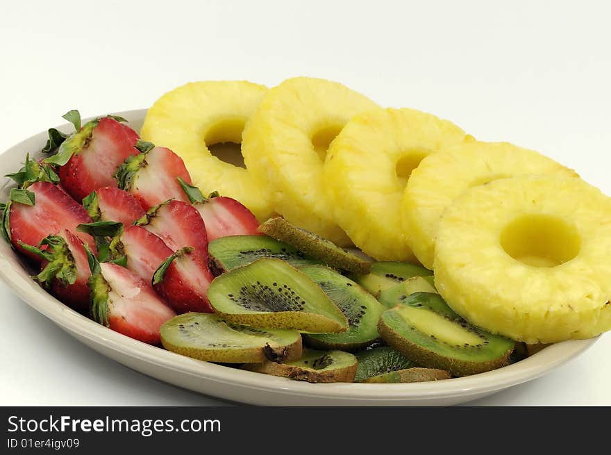 Fruit platter containing strawberries, kiwi fruits and pineapple slices. Fruit platter containing strawberries, kiwi fruits and pineapple slices