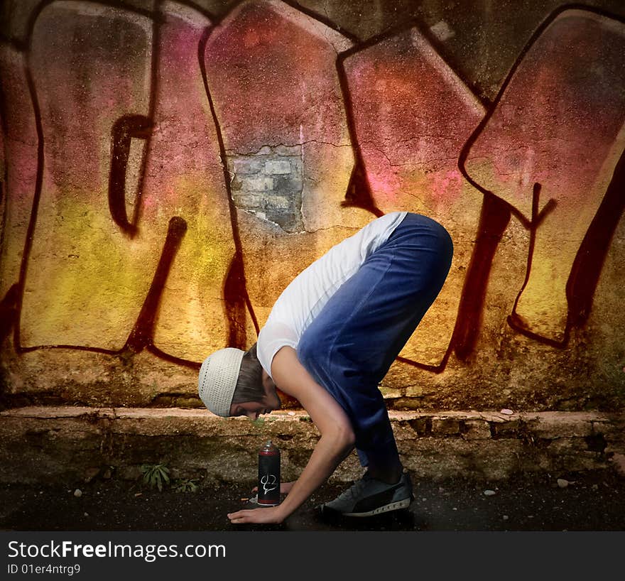 Young woman looking a air spray on a graffiti background