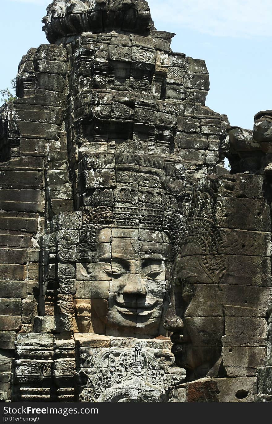 The contrast smile face of the stone sculpture in Bayon Wat,Siem Riep,Cambodia. The contrast smile face of the stone sculpture in Bayon Wat,Siem Riep,Cambodia