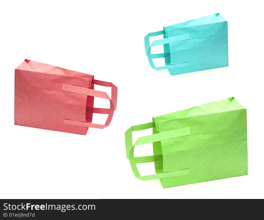 Shot of three coloured paper bags on white