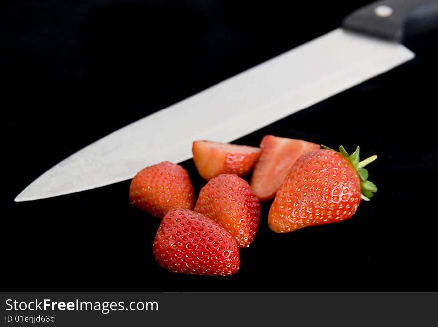 Freshly cut strawberries on black backround