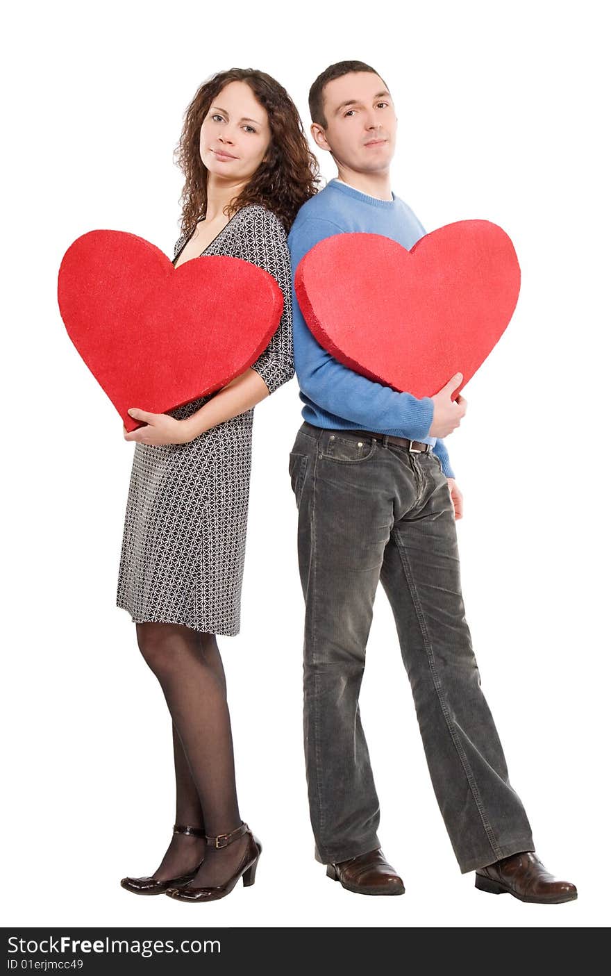 Couple standing holding hearts  isolated over white background