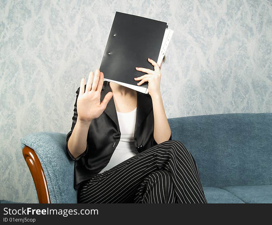 Businesswoman at office sitting on a sofa