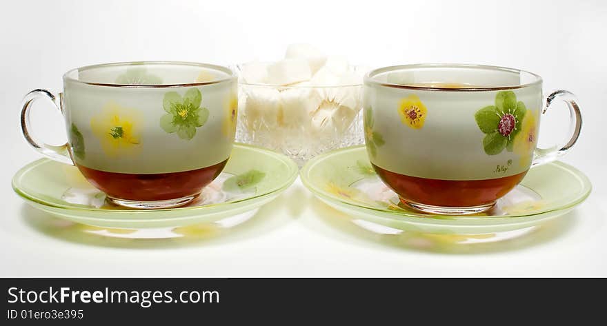 Two tea cups on a saucer