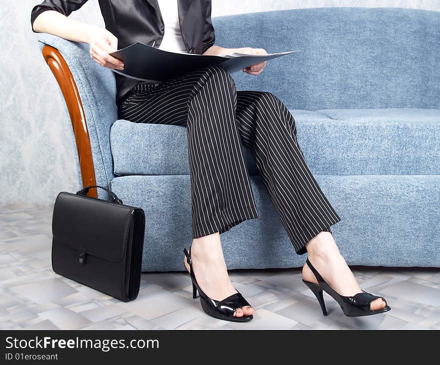 Businesswoman at office sitting on a sofa