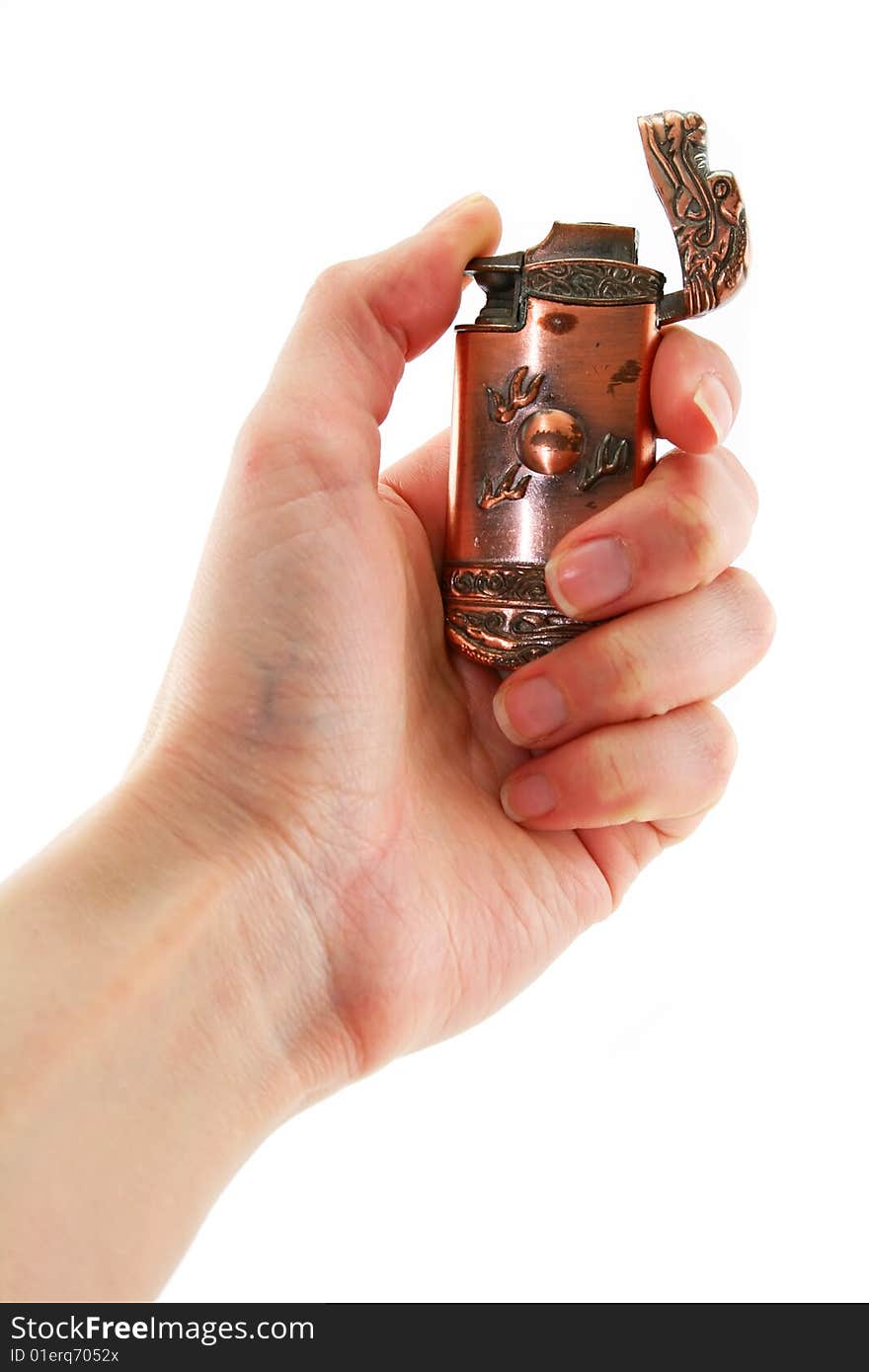 Female hand holds old bronze gas lighter isolated on a white background