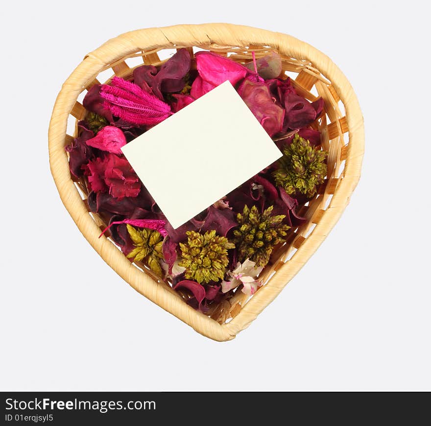 Heart-shaped basket with small clear sheet and flowers. Heart-shaped basket with small clear sheet and flowers