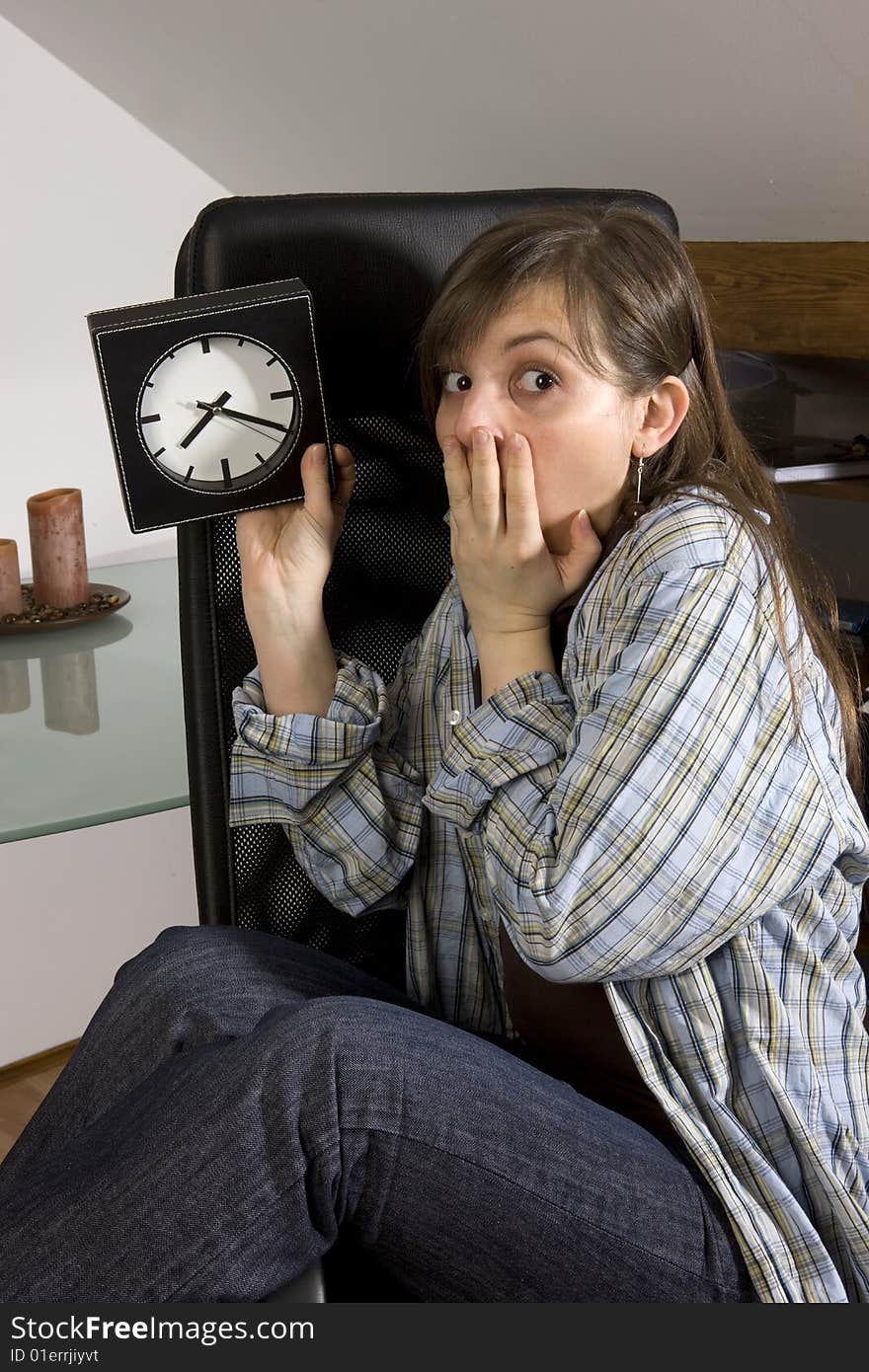 Young woman looks on watch. Young woman looks on watch