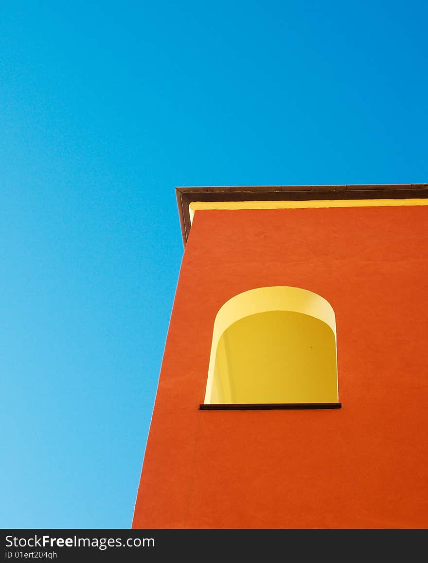 A colorful italian  building against a deep blue sky. A colorful italian  building against a deep blue sky.